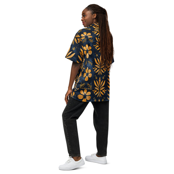 Young lady wearing the Golden Azure Camp Shirt from Amerukhan Basics Clothing, inspired by Egyptian styles and featuring symbolic floral images. Back view.