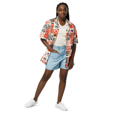 Young lady wearing the Ameru Camp shirt with striking Ameru print in deep orange, black, and white hues from Amerukhan Basics collection. Crafted with care, this button-up shirt blends tradition with contemporary style, offering comfort and sophistication.