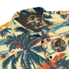 Image of the Amerukhan Surfing camp shirt with palm trees pattern, moorish surfer on the back, and Amerukhan surfing emblem on the left chest. Flat view.