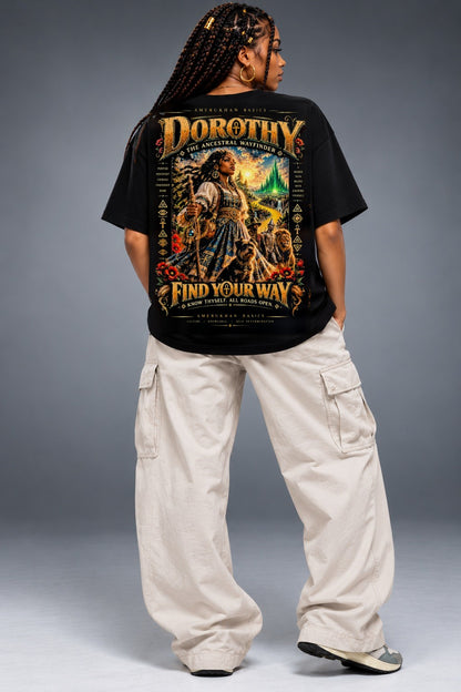 Model wearing the Dorothy Black heritage Wizard of Oz graphic tee, back view with oversized black tee and cream cargo pants