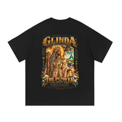Back print: Glinda, a regal Black empress with silver-threaded locs, gold crown and scepter, Black heritage Wizard of Oz graphic tee