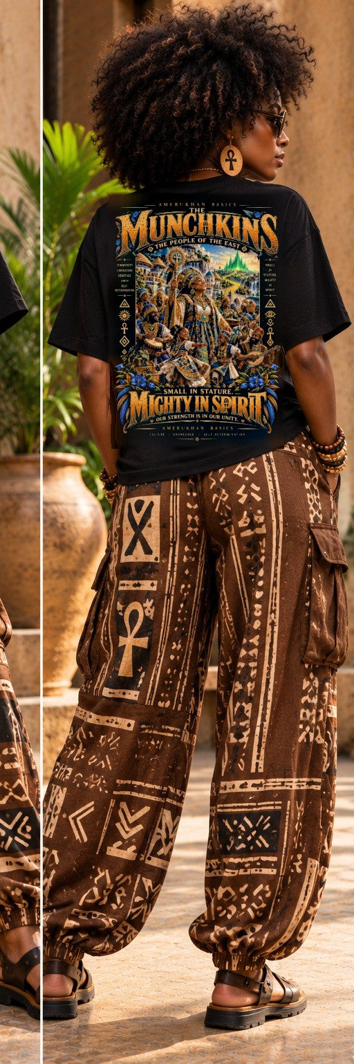 Model wearing the Munchkins Black heritage Wizard of Oz graphic tee, back view with mudcloth print pants