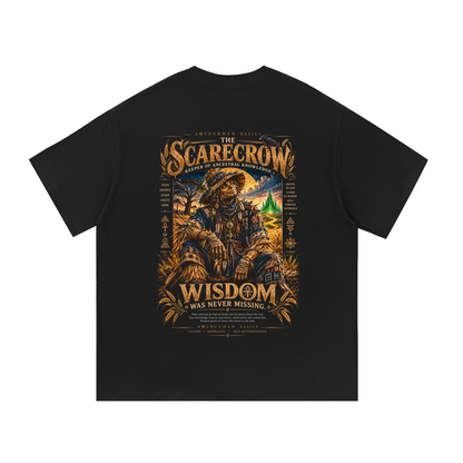 Back print: the Scarecrow, Keeper of Ancestral Knowledge, in indigo woven cloth among golden wheat, Black heritage Wizard of Oz graphic tee