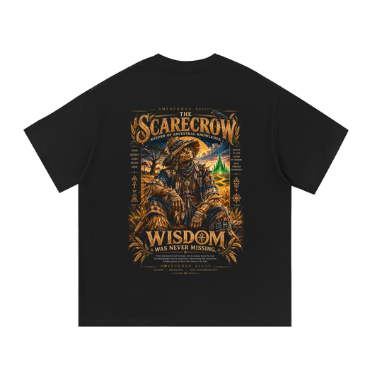 Back print: the Scarecrow, Keeper of Ancestral Knowledge, in indigo woven cloth among golden wheat, Black heritage Wizard of Oz graphic tee