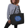 Image of a woman holding the Large organic tote bag featuring Ajna and Anahata Chakras design, perfect for yoga enthusiasts to carry your gear, showing the Anja Chakras.